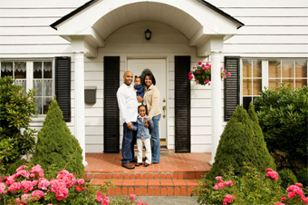 family in front of their new house